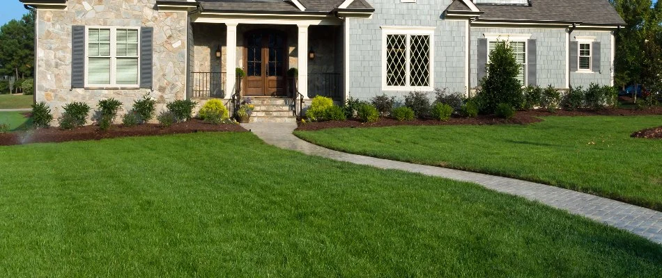Dark green lawn and a walkway to a house in Garfield, NJ.