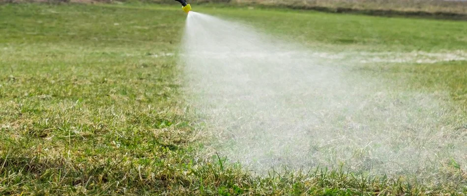 Lawn in Wayne, NJ, being sprayed with liquid aeration treatment.